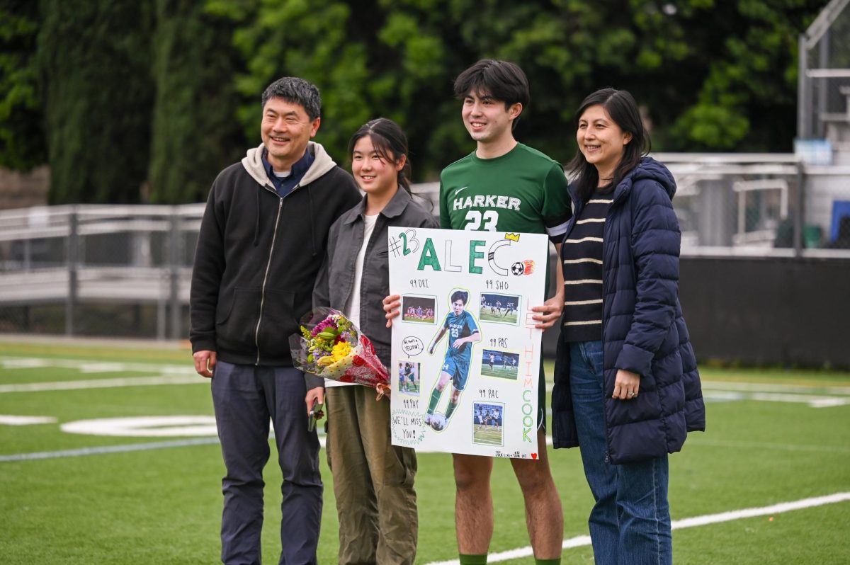 Midfielder Alec holds his poster while smiling for a photo with his family. “Senior night was really memorable with everyone coming together—the JV players, the varsity players and our friends,” Alec said. 