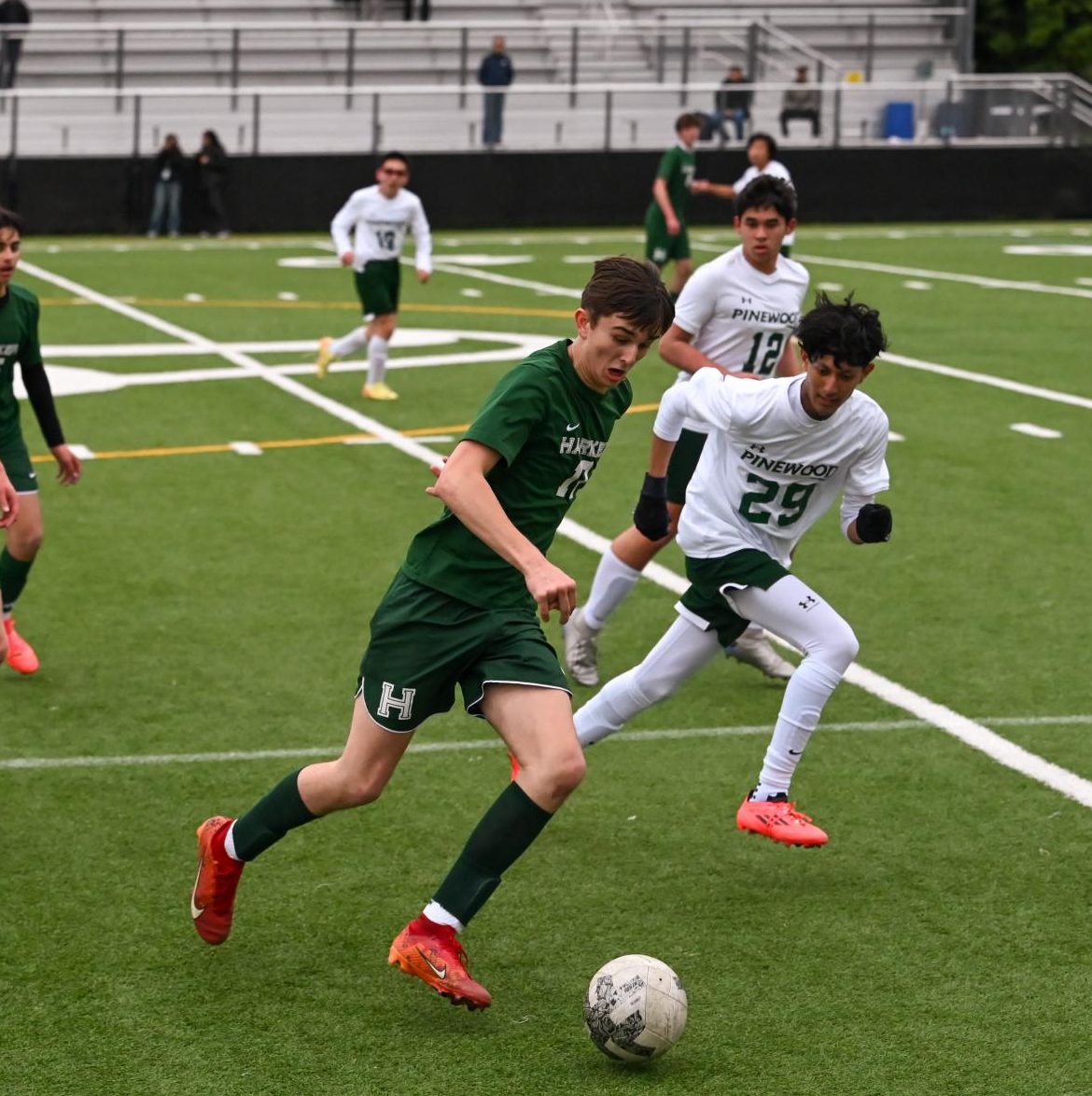 Vova dribbles the ball down the sideline past Pinewood defenders. Vova scored the final goal of the game, securing Harker’s win over Pinewood.