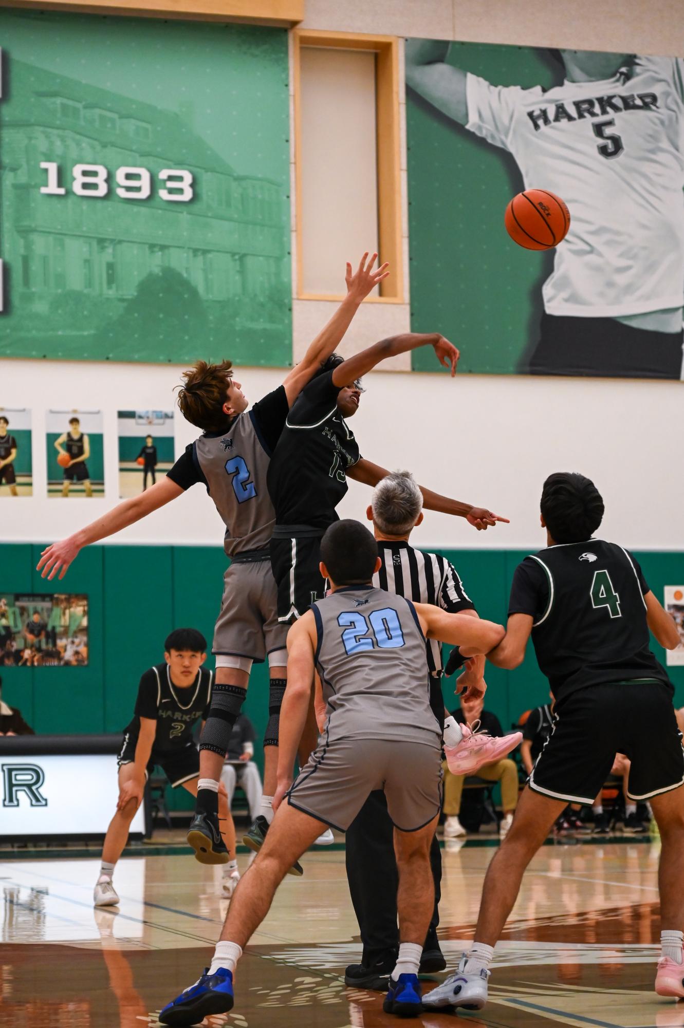 Power forward Rohit Yalla (12) jumps to win the tipoff for the Eagles. Rohit has played basketball at Harker for the past nine years. 