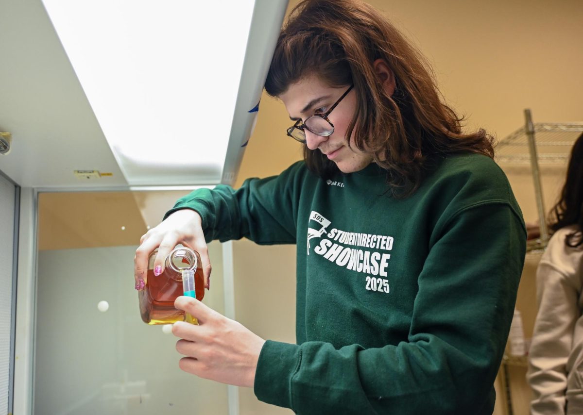 Honors Bioinformatics student Thomas Campisi (11) pours lysogeny broth, a nutrient-rich medium containing the bacteria ampicillin, into a test tube. The class introduces students with varying interests to understanding the vast amounts of data from DNA sequencing.