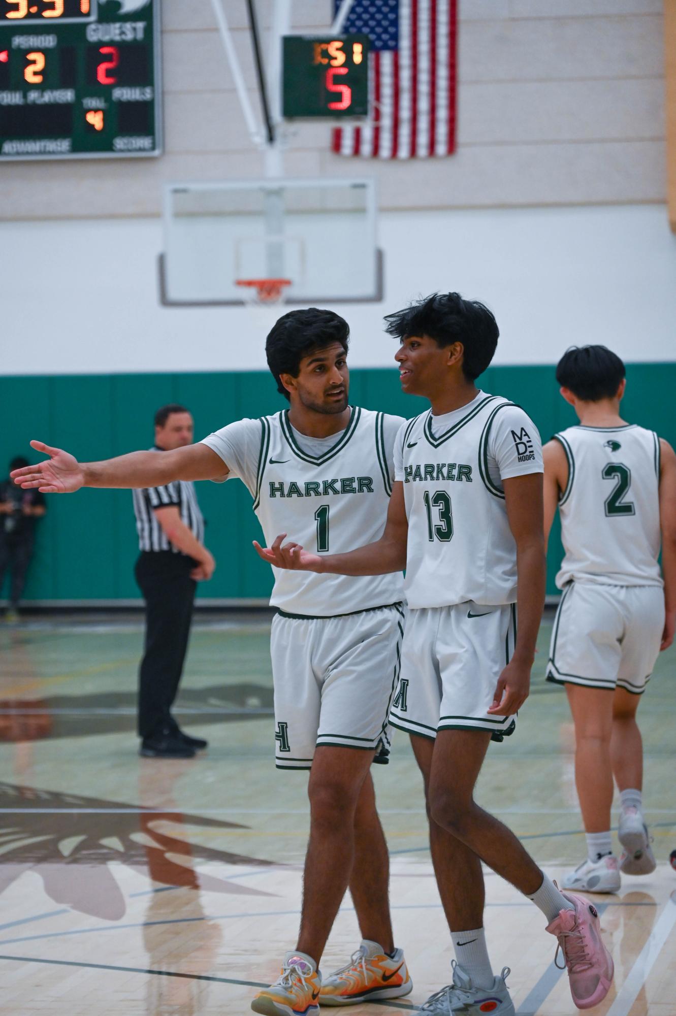 Power forwards Vyom Vidyarthi (12) and Rohit Yalla (12) discuss strategy between quarters. The team maintained constant communication to execute plays throughout the game.