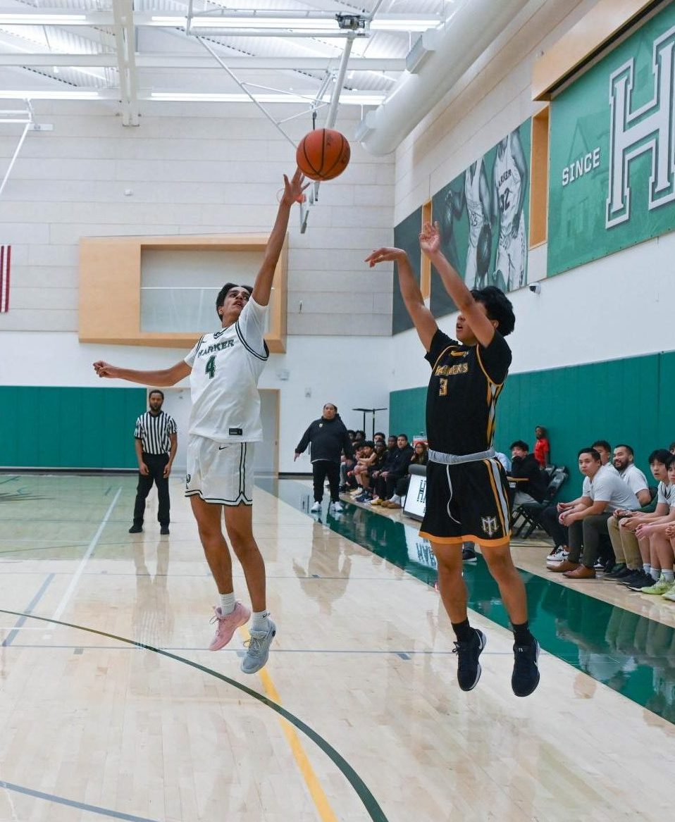 Shooting guard Advay Monga (12) attempts to block a Marina shot. Advay scored the Eagles' first points of the match.