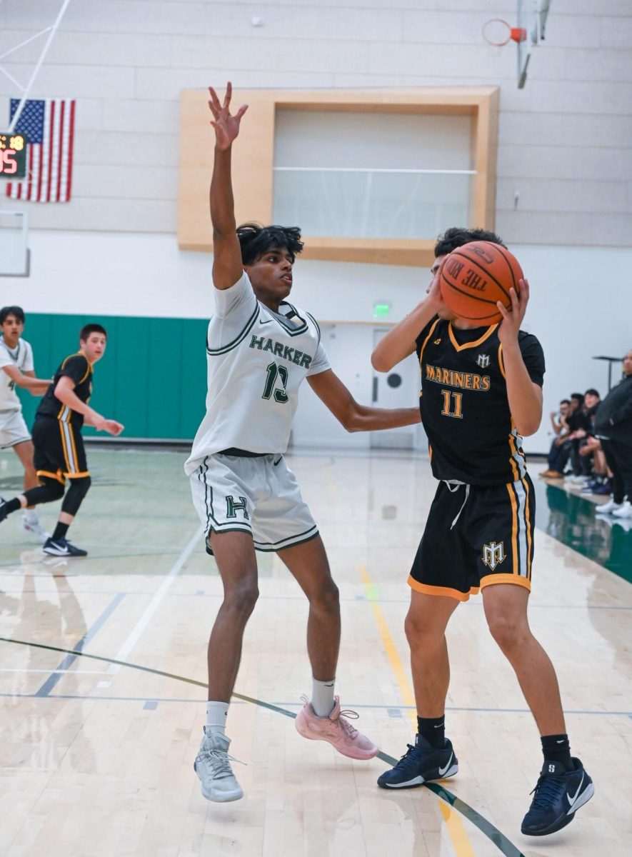 Power forward Rohit Yalla (12) jumps to block an opponent's pass. The Eagles competed for rebounds and successfully intercepted the Viking's passes to convert transition plays.