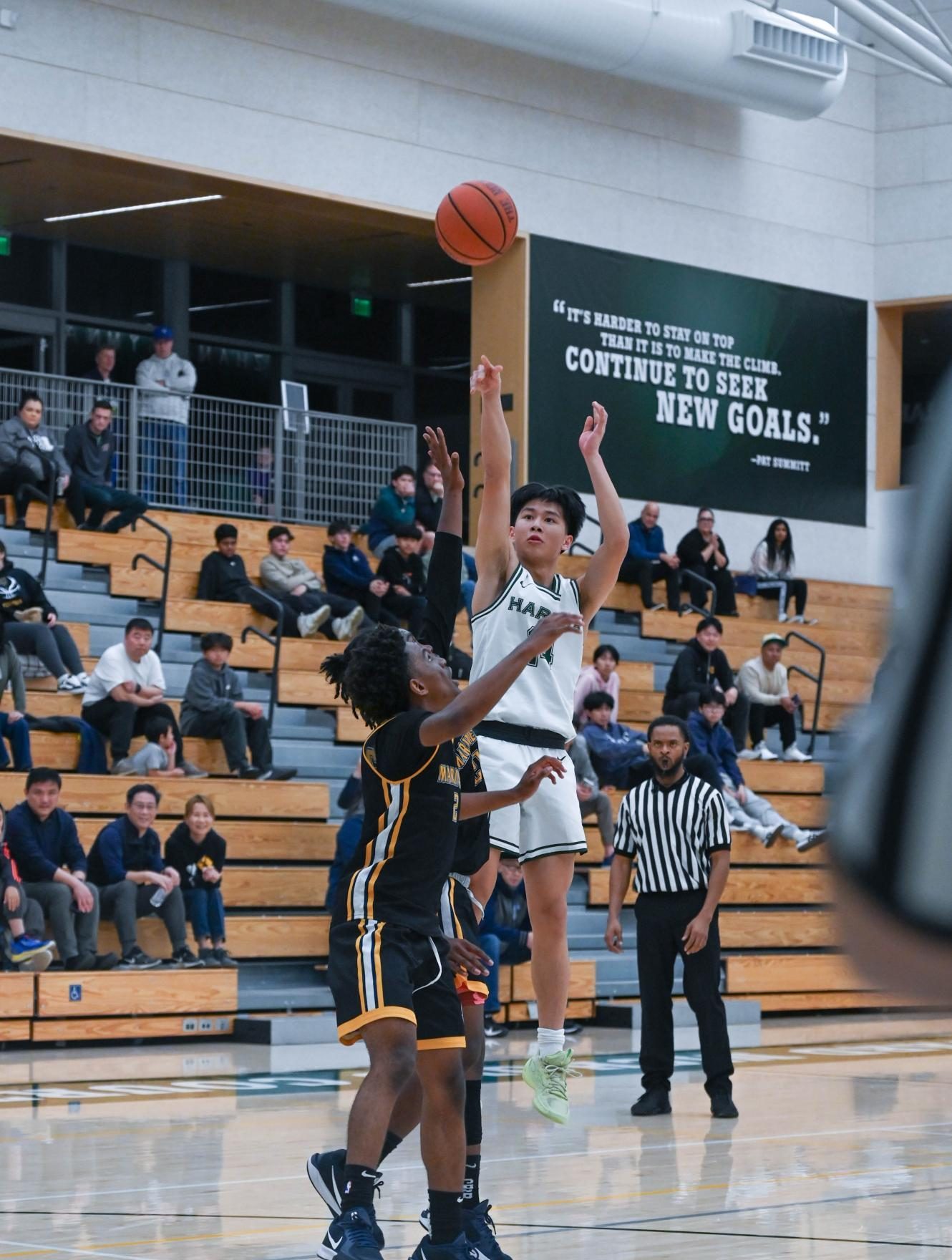 Shooting guard Lucas Huang (9) jumps for a three-pointer in the third quarter. Lucas created numerous scoring opportunities during the second half with his long range shots.