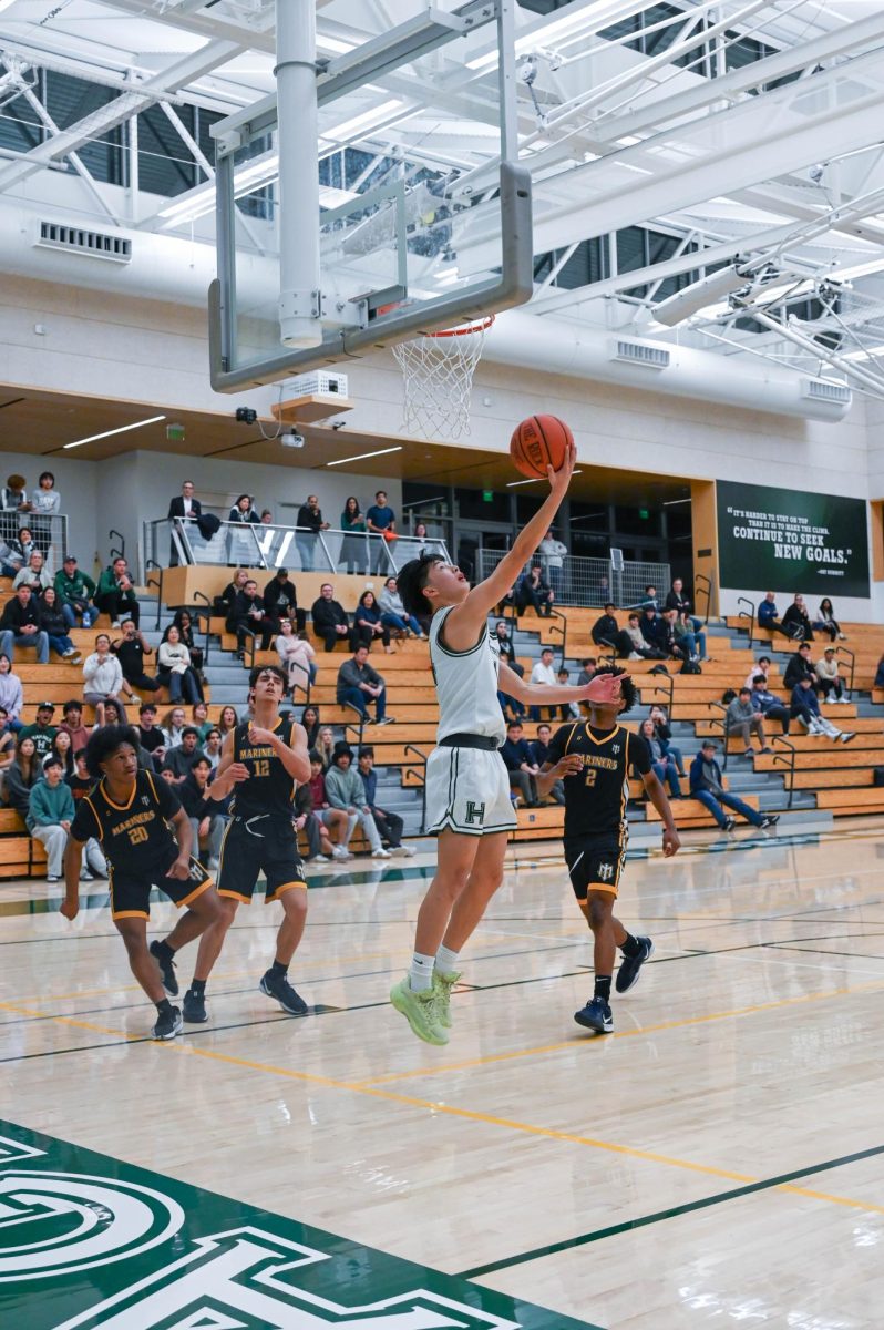 Shooting guard Lucas Huang (9) launches a backward layup during the fourth quarter. The Eagles capitalized on fast breaks to secure their 71-61 victory over Marina High School