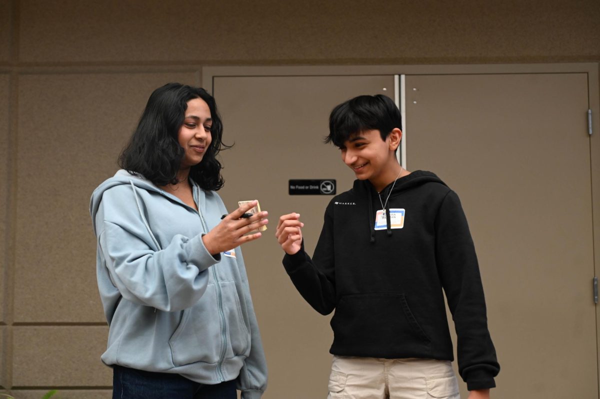 Senior Rithika Yamasani shows sophomore Ameera Ramzan a secret phrase during a game of charades aimed to demonstrate the importance of clear communication. Students broke into small breakout sessions focused on specific club leadership skills after lunch.