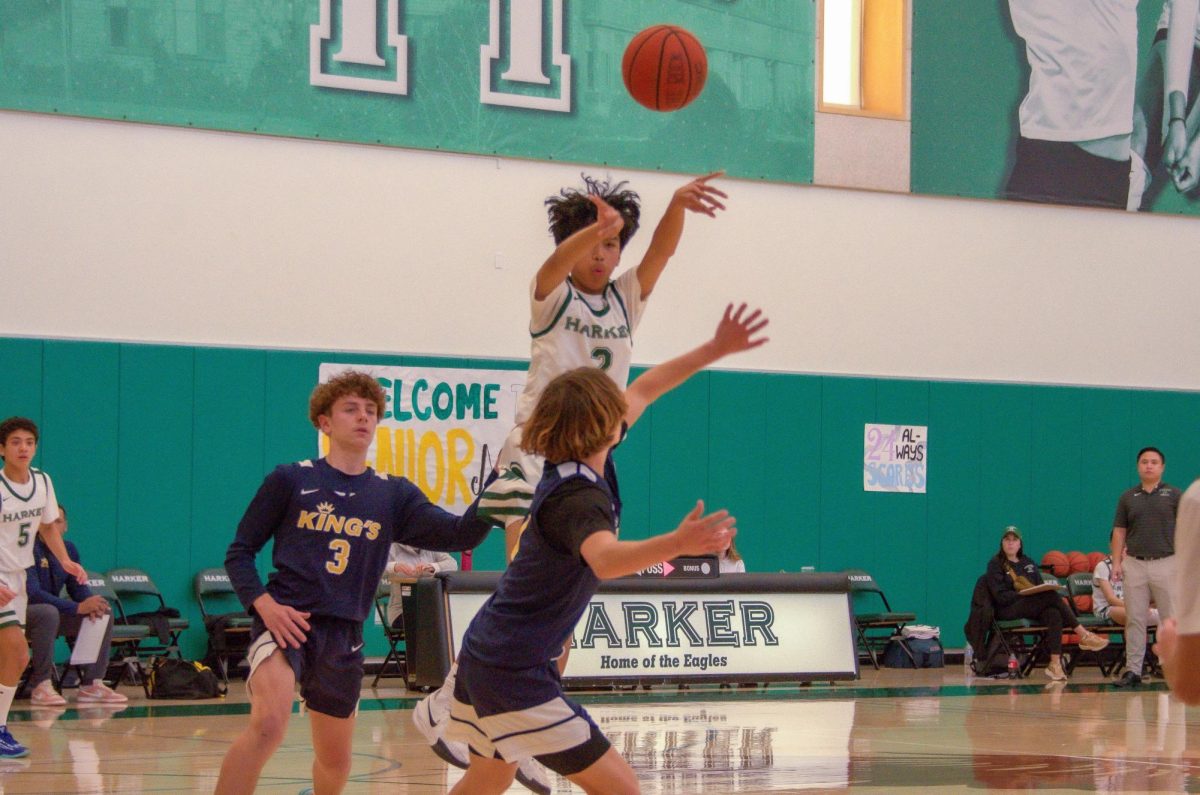 Point guard Kayvion Cruz (9) passes the ball for an open corner three-pointer after driving into the paint. Kayvion facilitated the Eagles offense throughout the match with multiple assists.