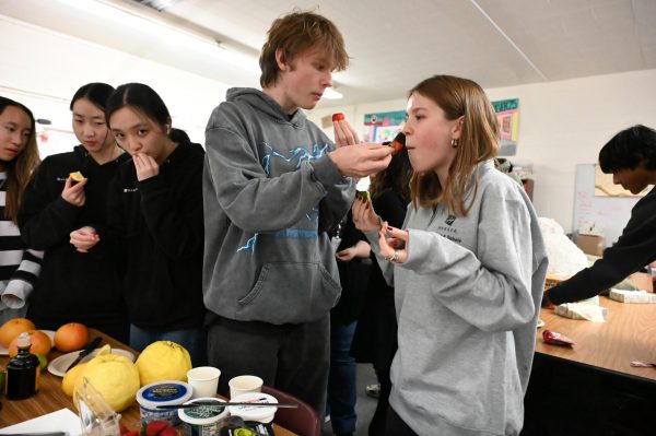 Sophomores Stellan Lindh and Vera Sorotokin taste strawberries after eating miracle berries. The fruits turn acidity in foods into sweetness by binding to sweet receptors in the mouth.