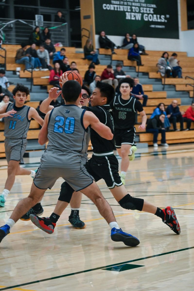 Shooting guard Caden Ruan (11) runs to make a layup while defending against Gryphons. The Eagles' offensive plays put them at a 45-21 lead at the end of the first half. 