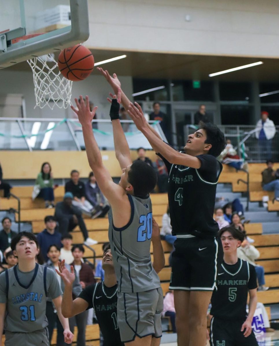 Co-captain and shooting guard Advay Monga (12) shoots a basket. Advay has played Harker basketball since fourth grade. 