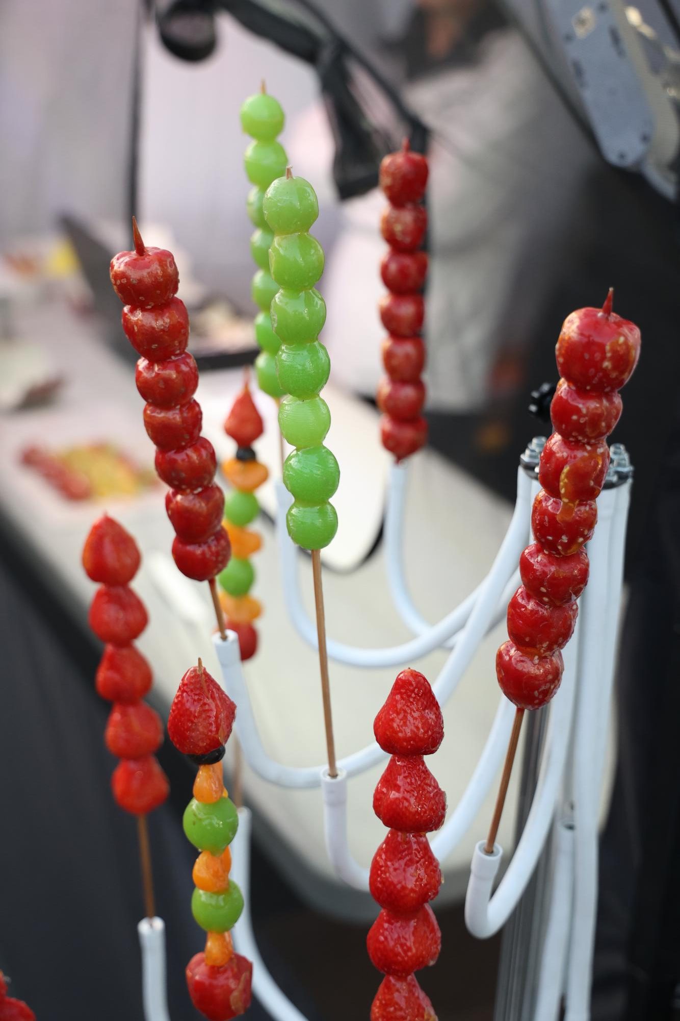 Street vendors sell tanghulu, a snack made of fruit with a hard shell of melted sugar. The snack is traditionally made with hawthorns.