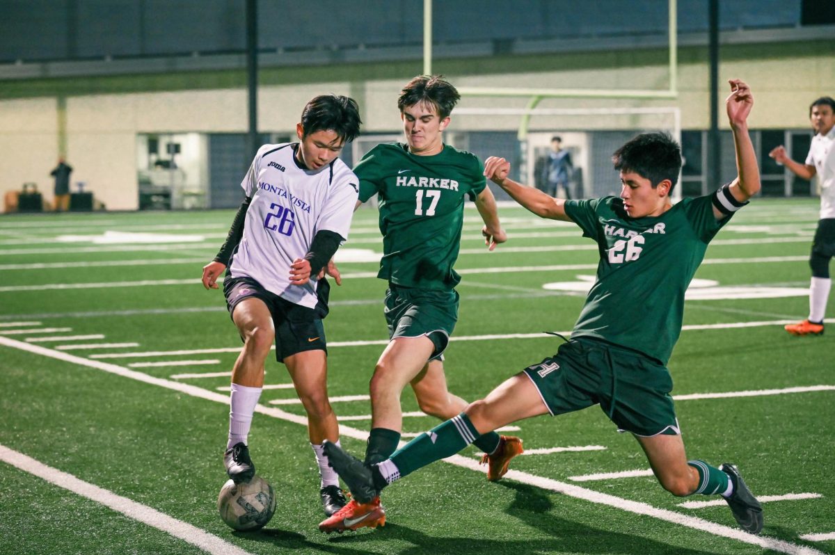 Varsity boys soccer captain Cyrus Ghane (11) stretches across the field to win the ball from the opponent. During tipping-point plays, captains step up to complete the task no matter the demands.