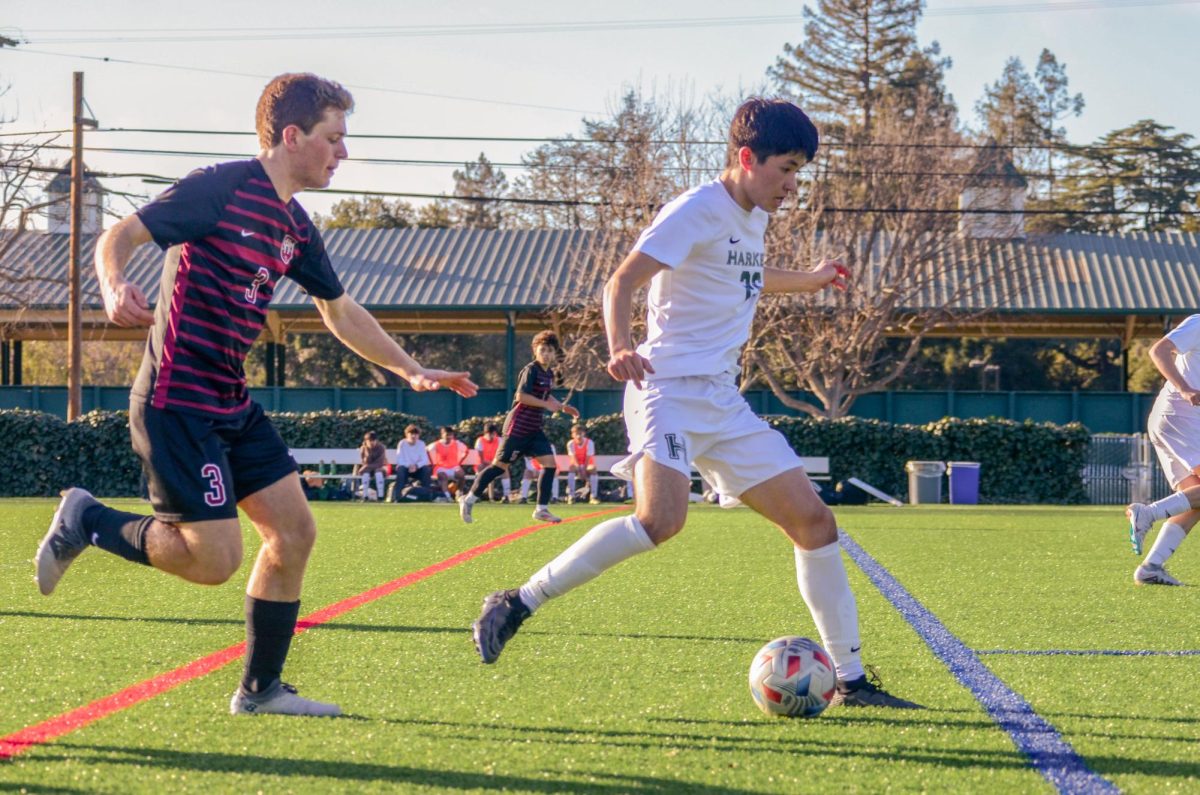 Forward Cyrus Ghane (11) prepares to pass the ball to midfielder Ryder Hewitt (11). The Eagles lost to Sacred Heart with a score of 0-2.