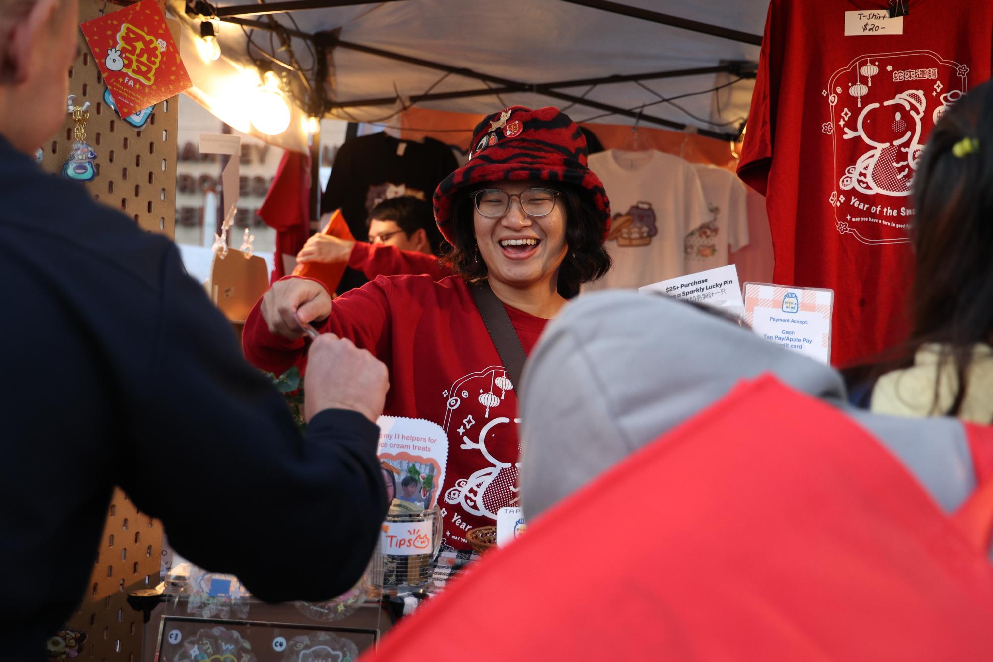 A street vendor sells Lunar New Year mementos at a stall. San Francisco hosts a parade and festival annually.