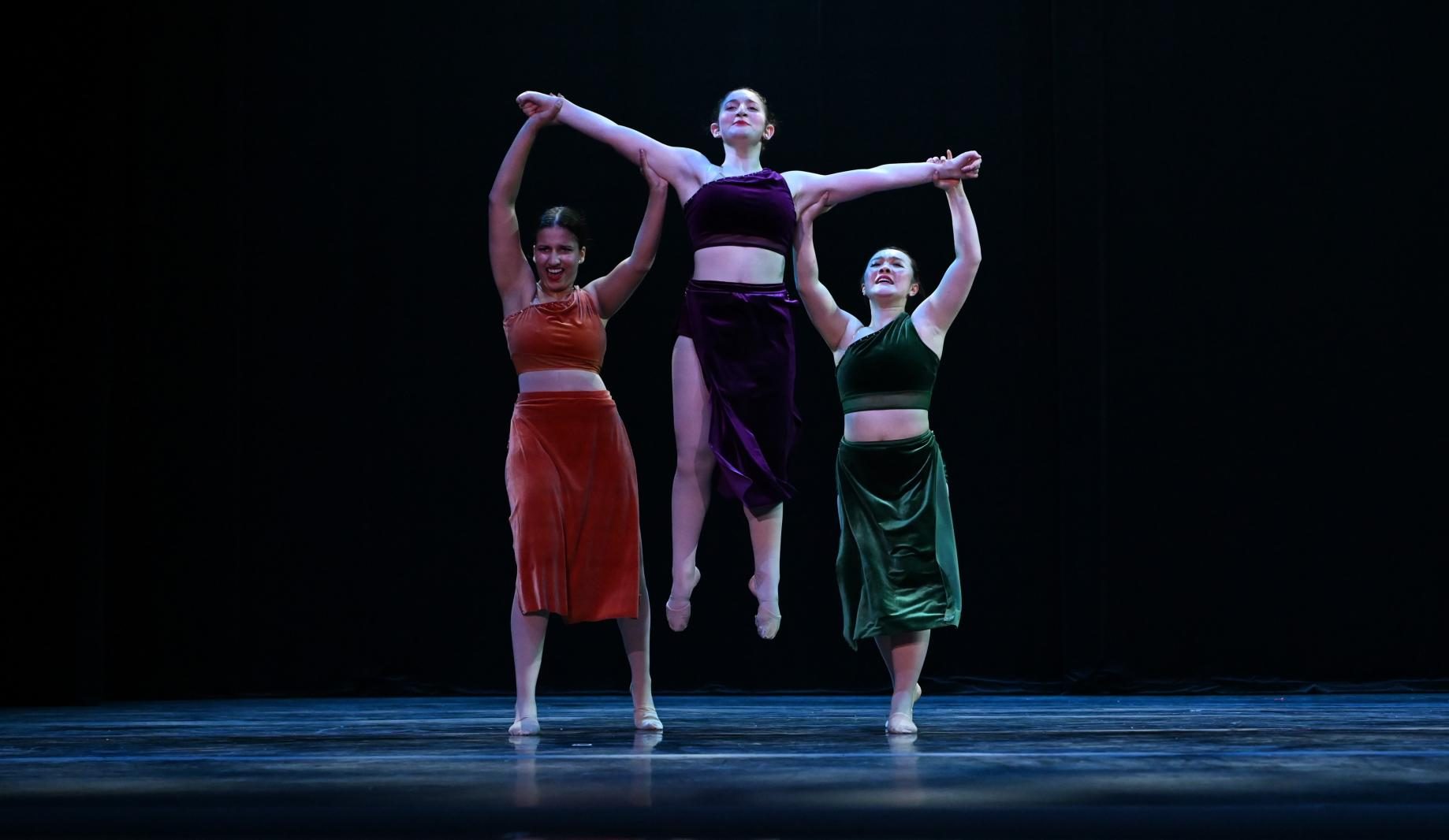 Yasmin Sudarsanam (12) and Sonia Yu (12) lift Maya Affaki (12) into the air during "Sisters." This dance was dedicated to Harker Dance Company's three seniors. 