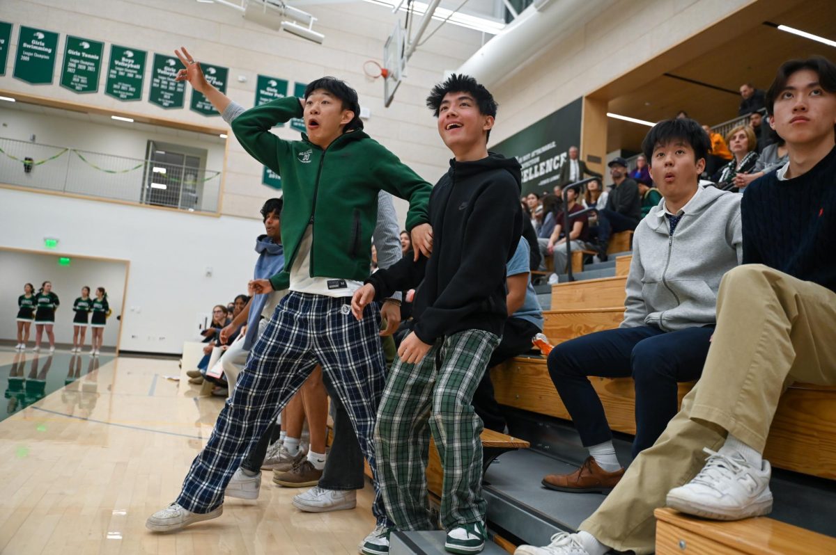 Seniors Bowen Xia, Caleb Tang, Kai Hong, and Gary Jin react to during girls basketball senior night. The team dominated in a wire-to-wire 57-15 win.