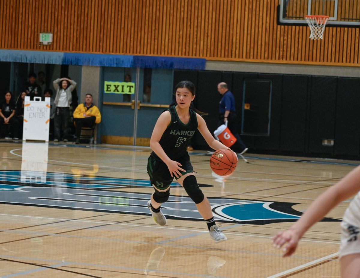 Shooting guard Claire Yu (11) runs down the center of the court to find a pass to a teammate. The Eagles maintained constant communication and dynamic movement to keep possession of the ball.