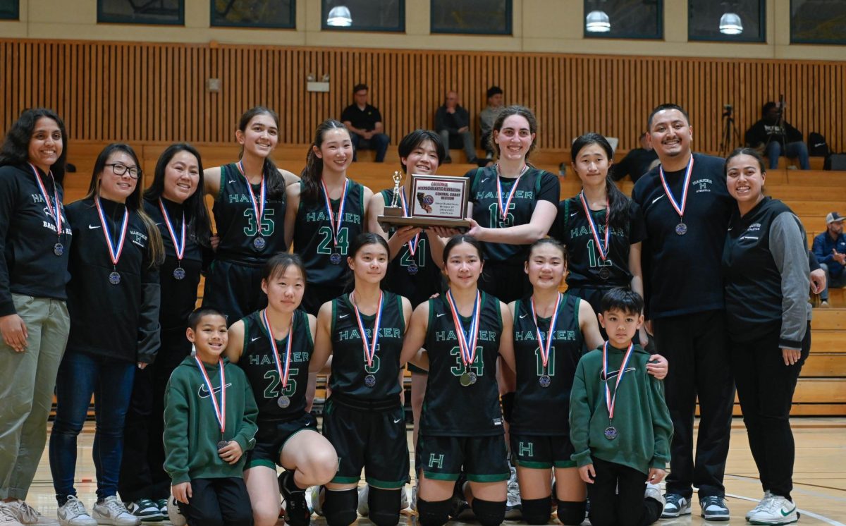 The team poses for a photo during the post-match ceremony. “It's only the second time in school history that we made it this far, so I'm very proud of us and how hard we pushed ourselves,” center Emily Mitnick (12) said.