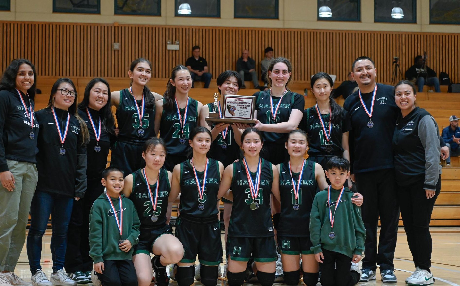 The team poses for a photo during the post-match ceremony. “It's only the second time in school history that we made it this far, so I'm very proud of us and how hard we pushed ourselves,” center Emily Mitnick (12) said.