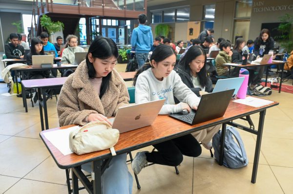 Frosh Rachel Li, Debby Zhu and Regina Zhang write code on their laptopsduring the contest. Their team competed in the advanced division.