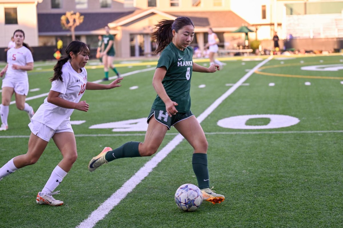 Midfielder Eva Cheng (11) evades a pursuing Mills High School defender. The team ended with a 6-9-3 overall record.