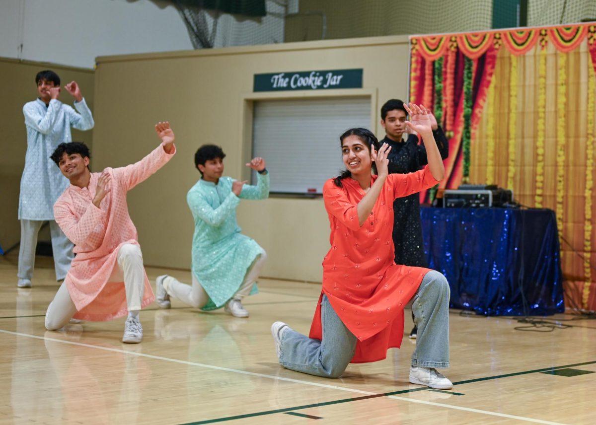 Senior Navya Samuel strikes the ending pose in the seniors’ dance to “Badtameez Dil.” Bollywood night performances included dance, singing and instrumental covers.