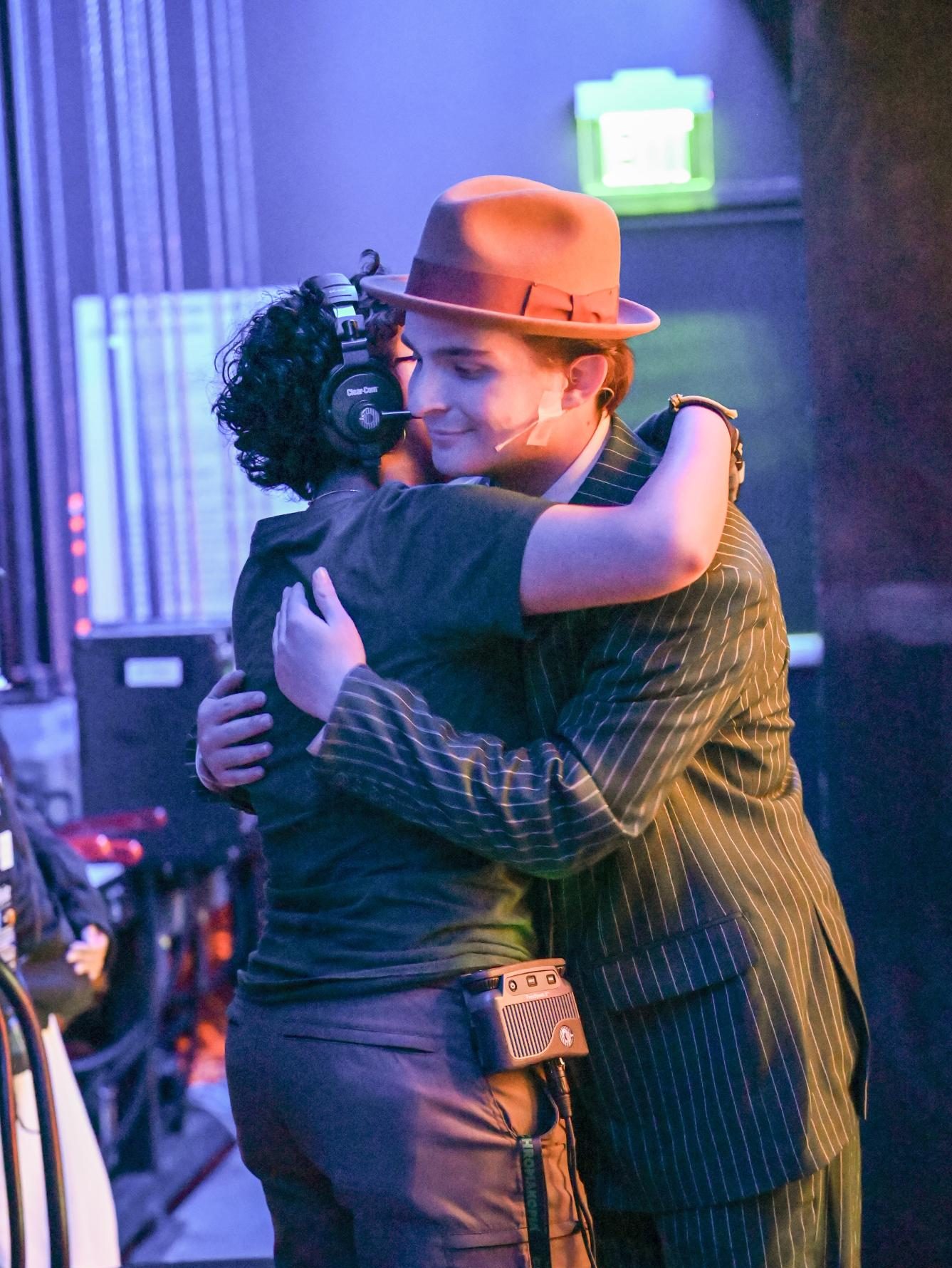 Seniors Sam Parapudi and Leo Sobczyn hug each other backstage. The two have been working together in Harker productions throughout high school as part of the certificate program.