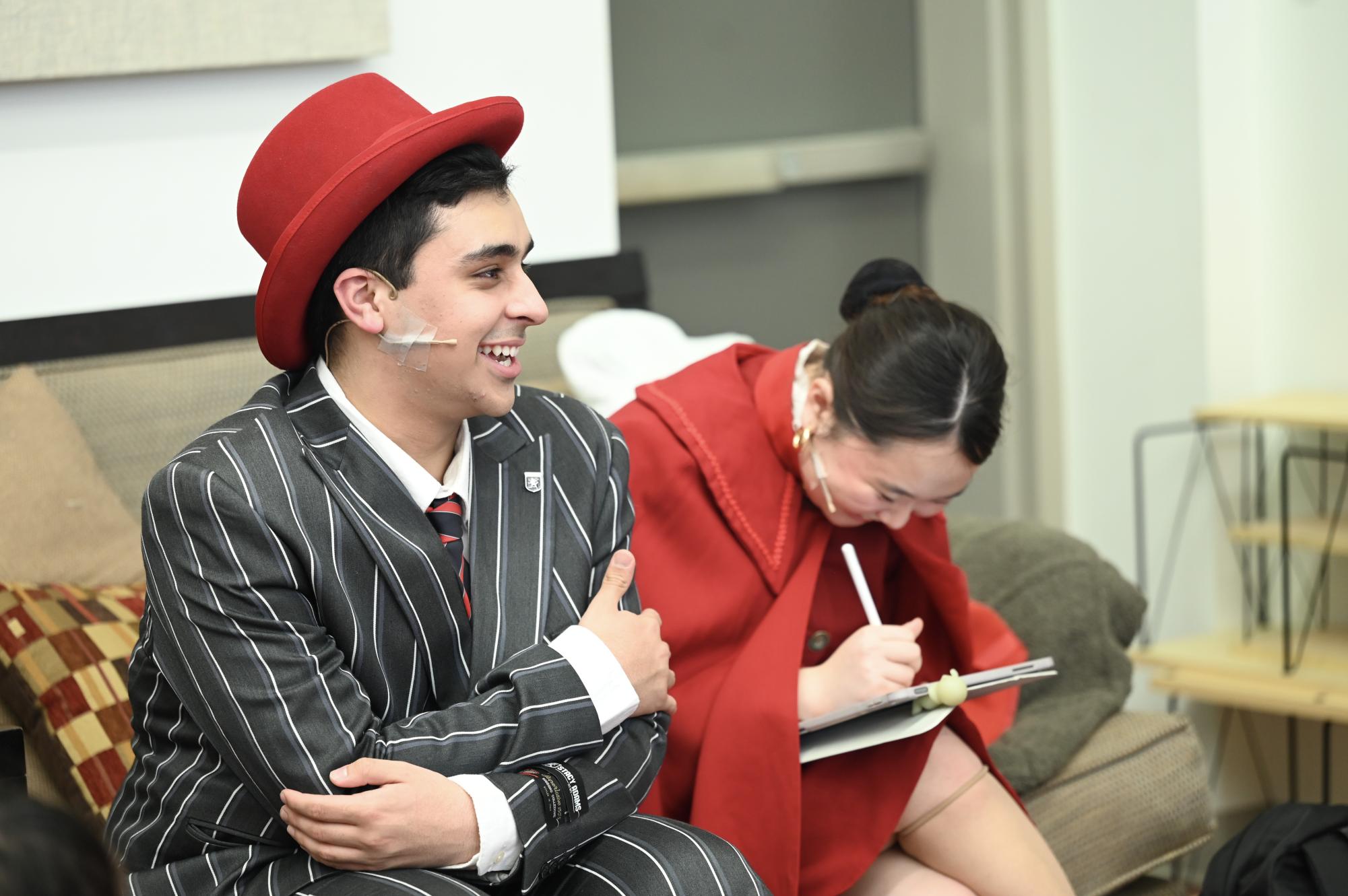 Sophomore Omar Khan sits in room 501 prior to his appearance on stage. Offstage, many cast members did their homework and talked to each other.