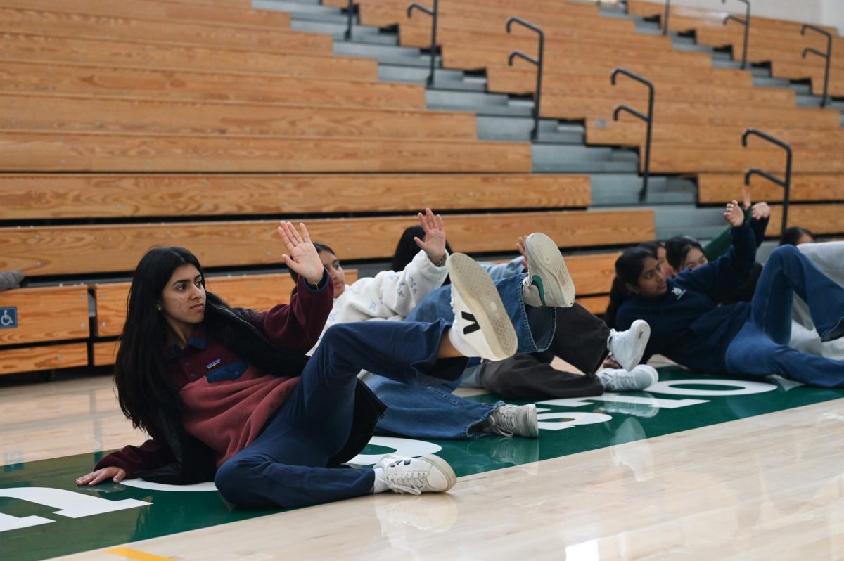 Junior Sofia Shah practices a technique to defend against an attack from the ground. CEO of Wushu Central Martial Arts Academy David Chang taught the class, demonstrating simple maneuvers that could prove life saving in an assault.