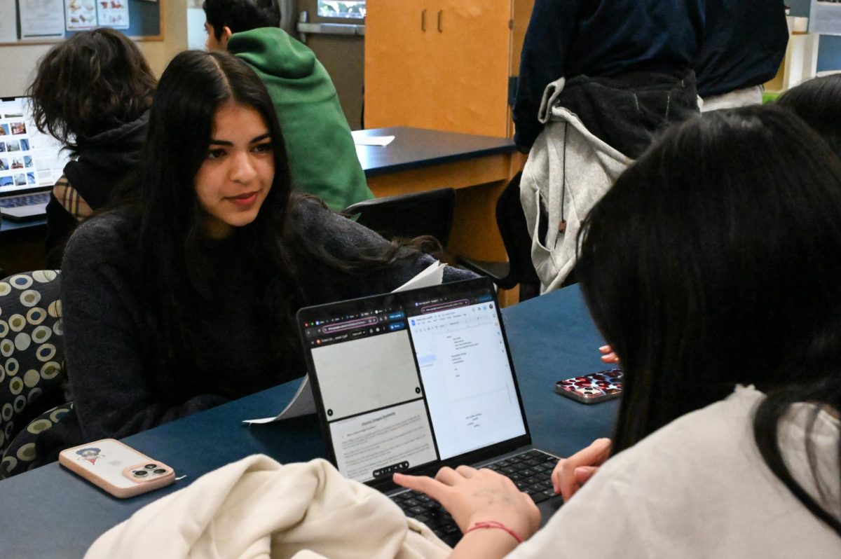 Med Club officer Kimi Yashar (11) acts as afflicted patient as participants collaborate to diagnose her. Members analyzed symptoms and conducted mock medical tests to reach an accurate diagnosis.