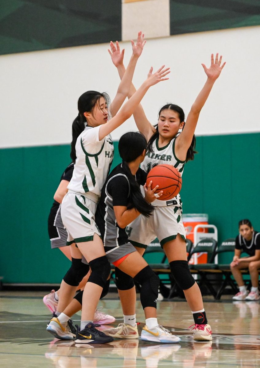 Jillian Chen (9) and Alicia Yan (11) use a double team to trap a Castilleja player. The Eagles swept all members of the West Bay - Skyline League except for King's Academy and finished atop the league at the end of the season.