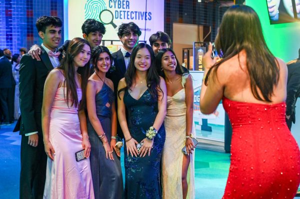 A group of juniors pose before the camera near the Tech Interactive exhibits. Students commemorated their school year with a night of dancing and celebration at prom on April 19.