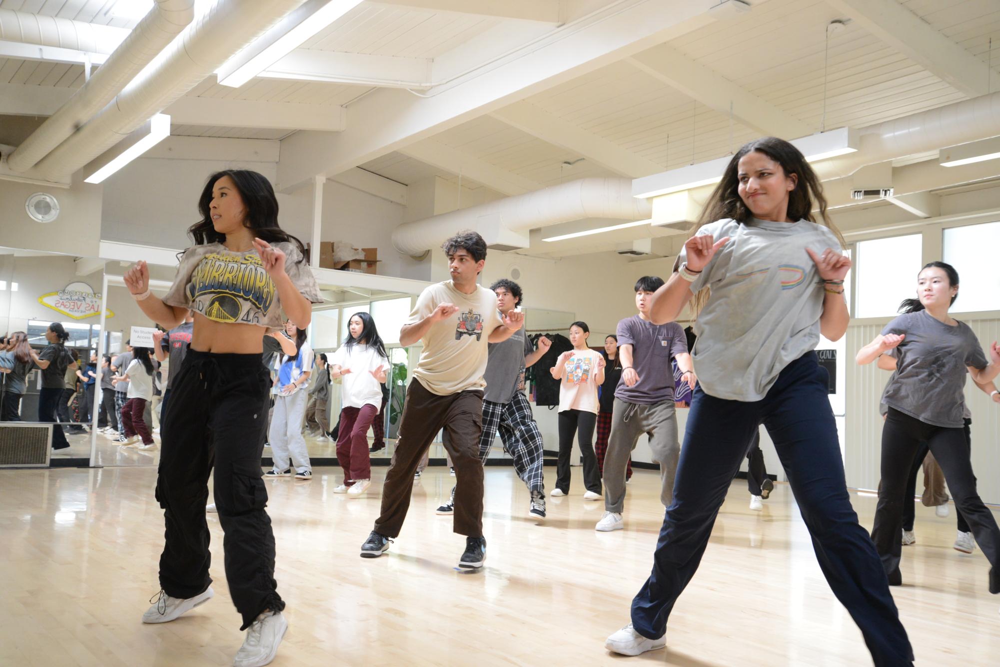 Captain of Harker Dance Company Yasmin Sudersanam dances alongside NBA dancer and alum LeAnn Reidenbach ('17) during the master class. Students followed Reidenbach's choreography as they explored professional-level movement and performance techniques.