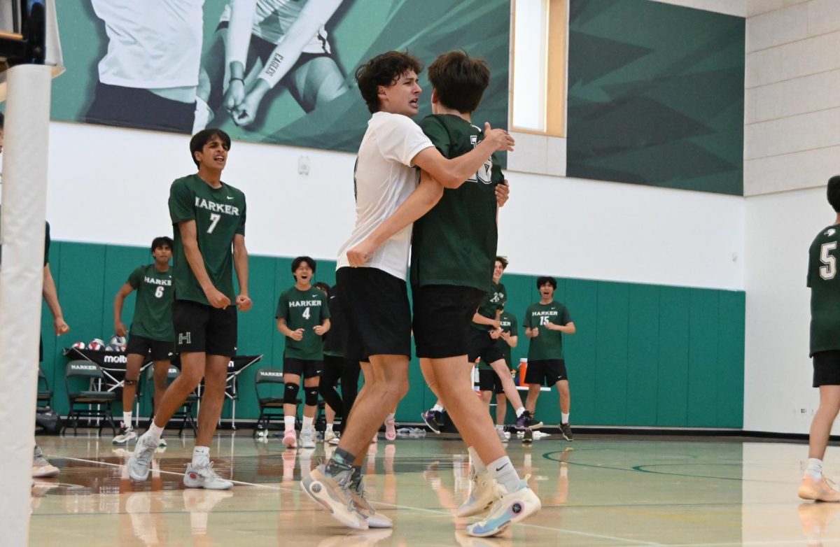 Senior libero Jacob Smith gives outside hitter Topaz Lee (11) a hug to celebrate a point. Topaz made multiple kills throughout the game, scoring many points for the team.