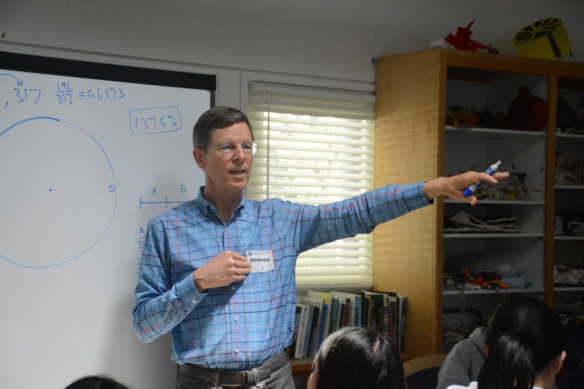 Stanford University lecturer John Edmark explains the mathematics behind his spiral artwork during the Math Club and Art Club joint workshop.  Edmark described the relationship between the golden ratio and the Fibonacci numbers, both of which are present in spirals in nature.