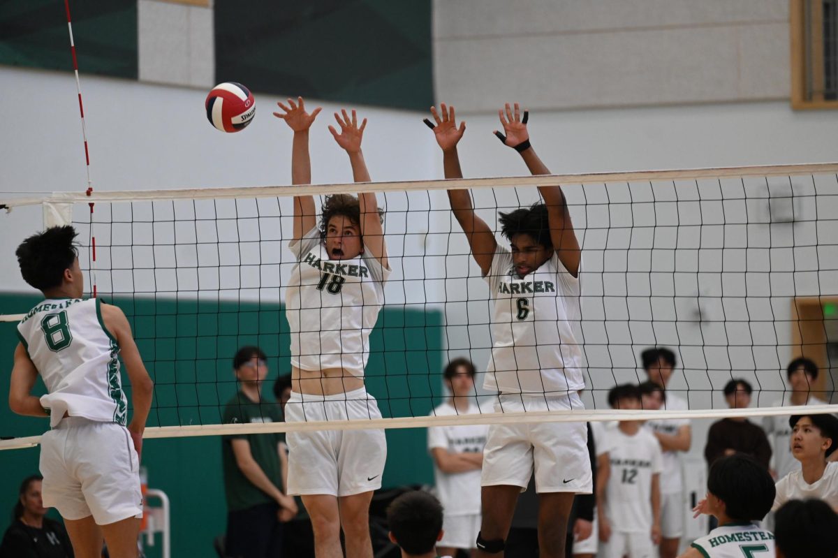 Opposite hitter Liam Jeffers (12) and middle blocker Rahul Yalla (12) block an incoming ball. Along with defending balls, Rahul played offense by executing many hits.