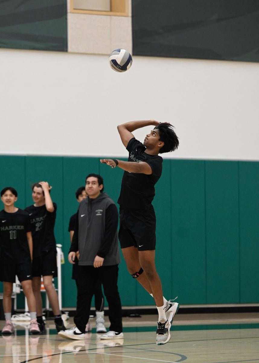 Co-captain middle blocker Rahul Yalla (12) serves the ball. In the first set, he went on a two point serving streak.