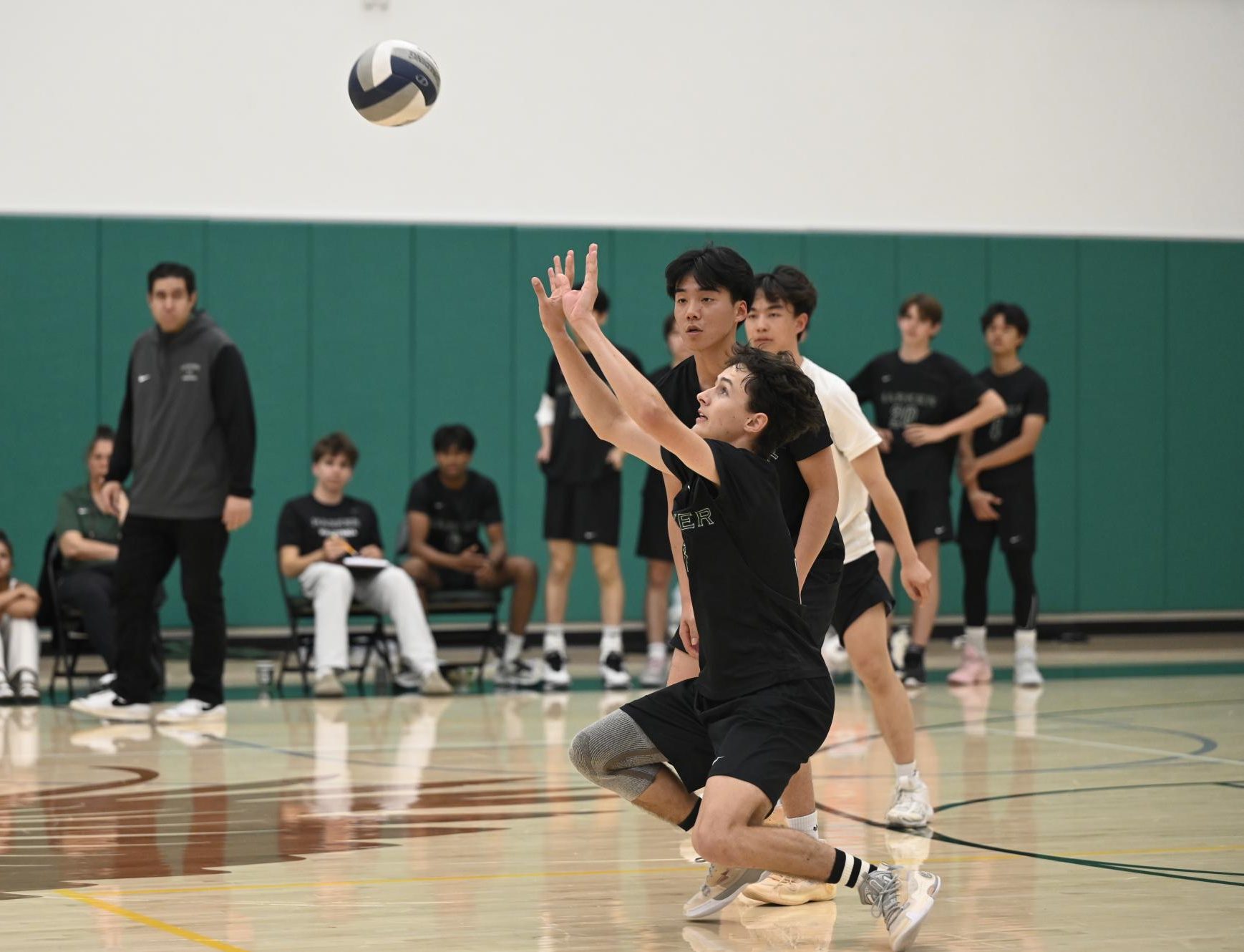 Outside hitter Jacob Smith (12) returns a hit by Homestead. Because of the injury of teammate Topaz Lee (11), he had to step into the outside hitter position instead of libero.