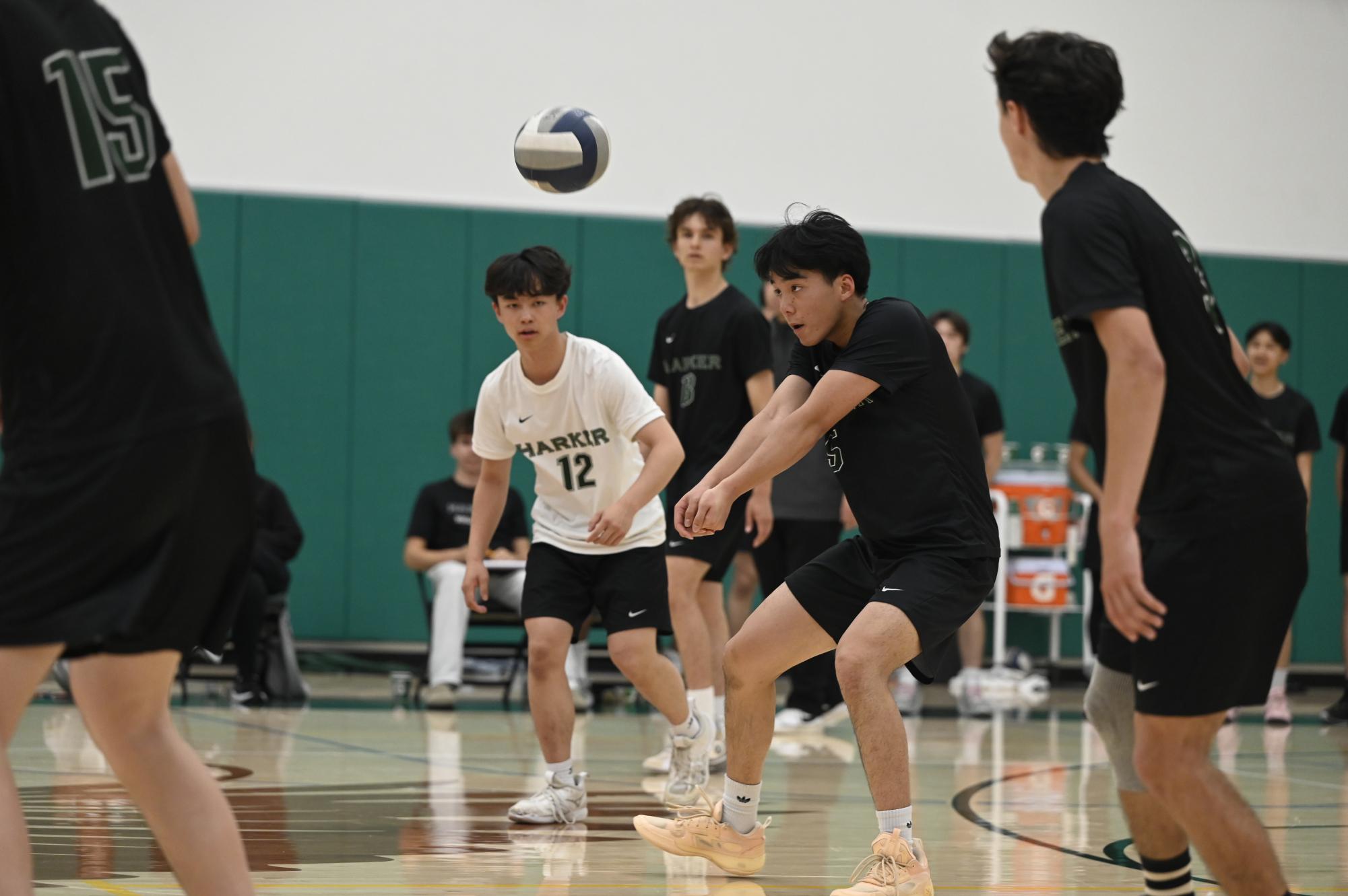 Co-captain outside hitter Aaron Guo (12) returns a serve by the Mustangs. He worked with libero Luke Wu (11) and outside hitter Jacob Smith (12) in defense.