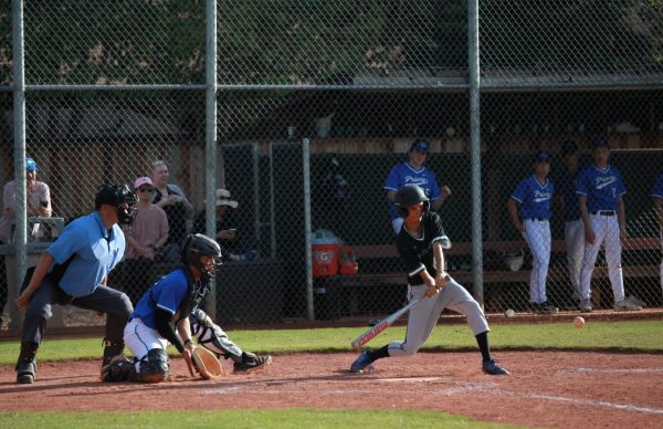 Senior Saahil Herrero takes a swing. In the sixth inning, Saahil hits a ball towards second base and nearly makes it to first base before being tagged out by a Priory outfielder.