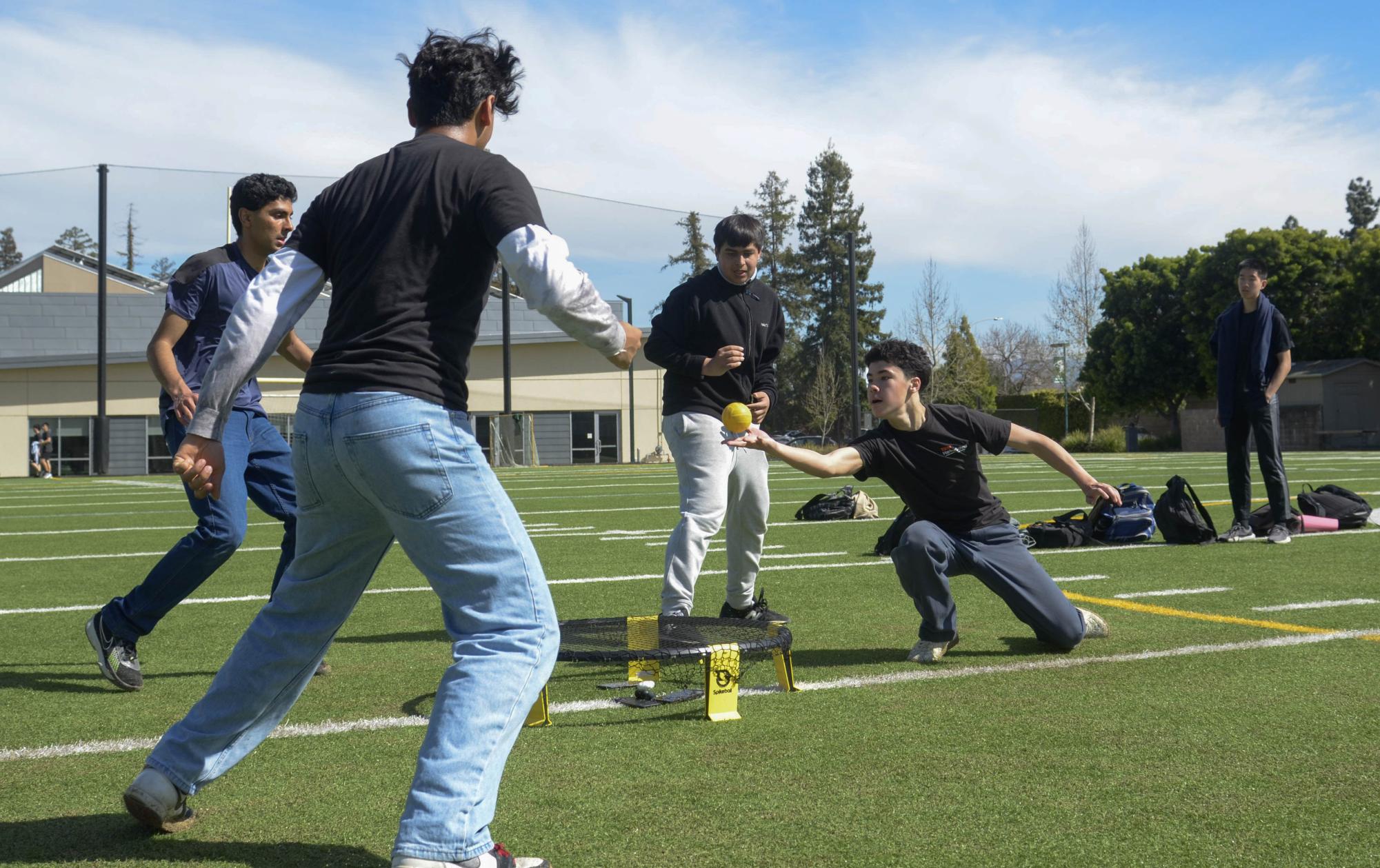 David Kelly (10) controls the spikeball, setting up a spike for his teammate Yash Belani (10). Since spikeball is a fast-paced game, players must transition quickly from defense to offense.
