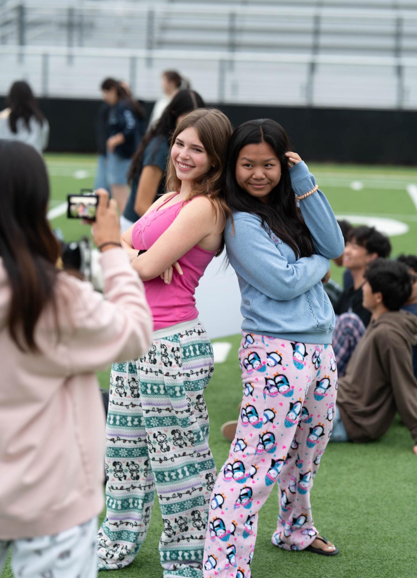 Striking a pose, seniors Audrey Dagum and Brooke Kubose pose for a photo. Many students wore pajamas before changing into other outfits for classes later in the day.