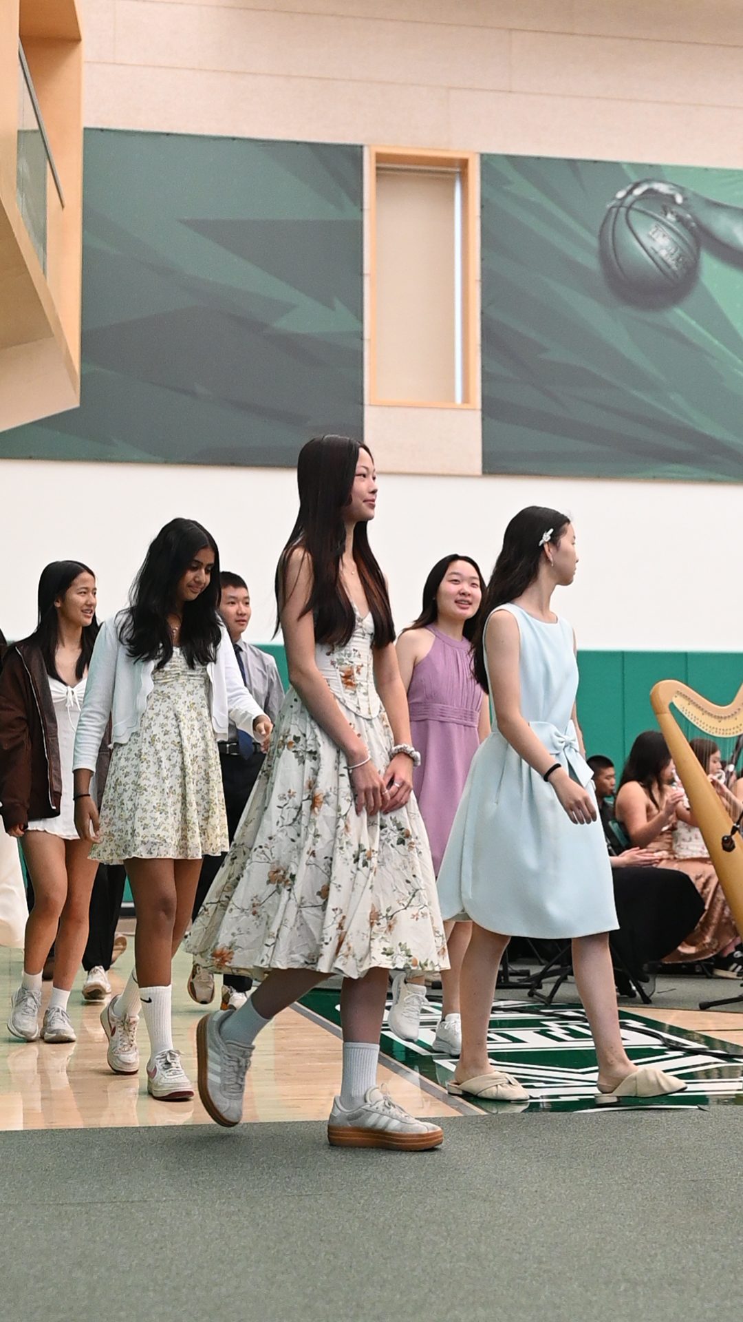 Frosh students smile as they enter the Zhang Gymnasium, receiving a standing ovation from the school. “Matriculation is important to the frosh because it gives them their first impression of what our school is going to be like,” ASB President Luke Wu (12) said.