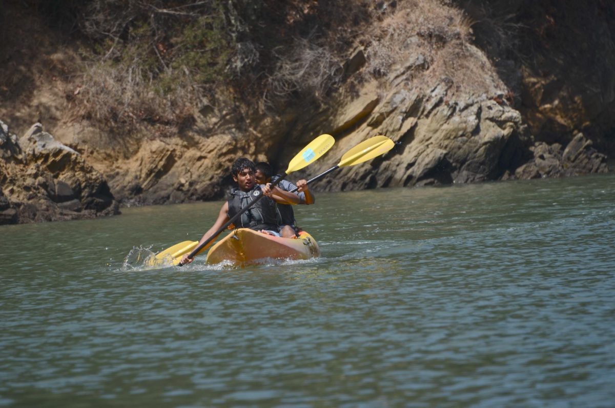 Chanting to coordinate their paddling, juniors Arav Vuppala and Neel Kumar accelerate on the kayak. Students also swam, played sports, and enjoyed the beach at Ayala Cove.