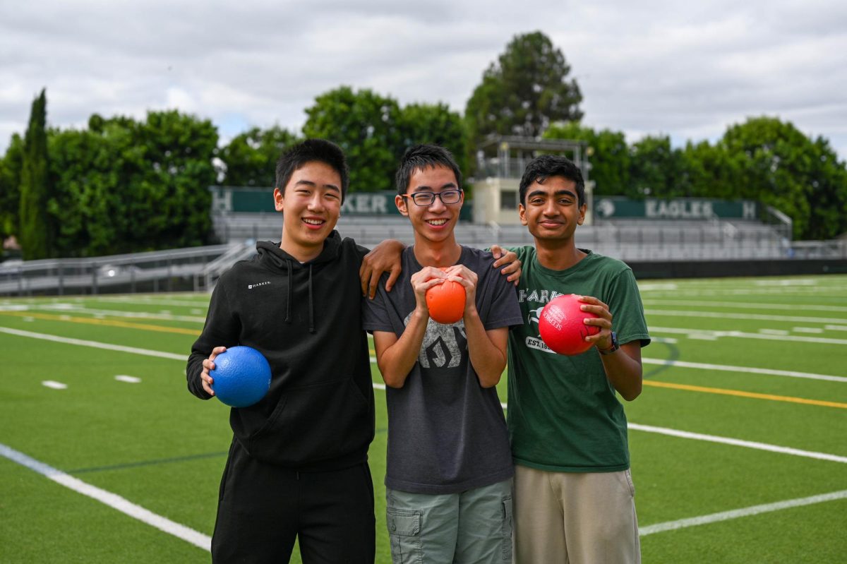 Dodgeball Club co-founders Sanjith Senthil (11), Haofang Zhu (11) and Kevin He (11) hold up dodgeballs on Davis Field. They founded the club to give students an opportunity to be physically active while having fun.