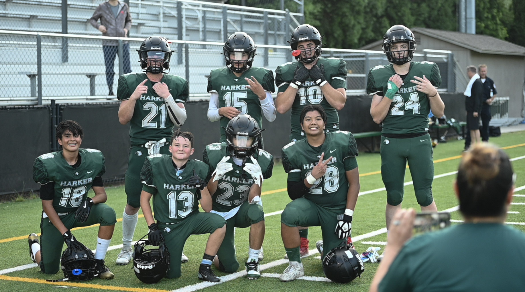 The varsity football team poses for a photo after the game. This year, their roster is smaller than ever, and they compete in 8-man matches.