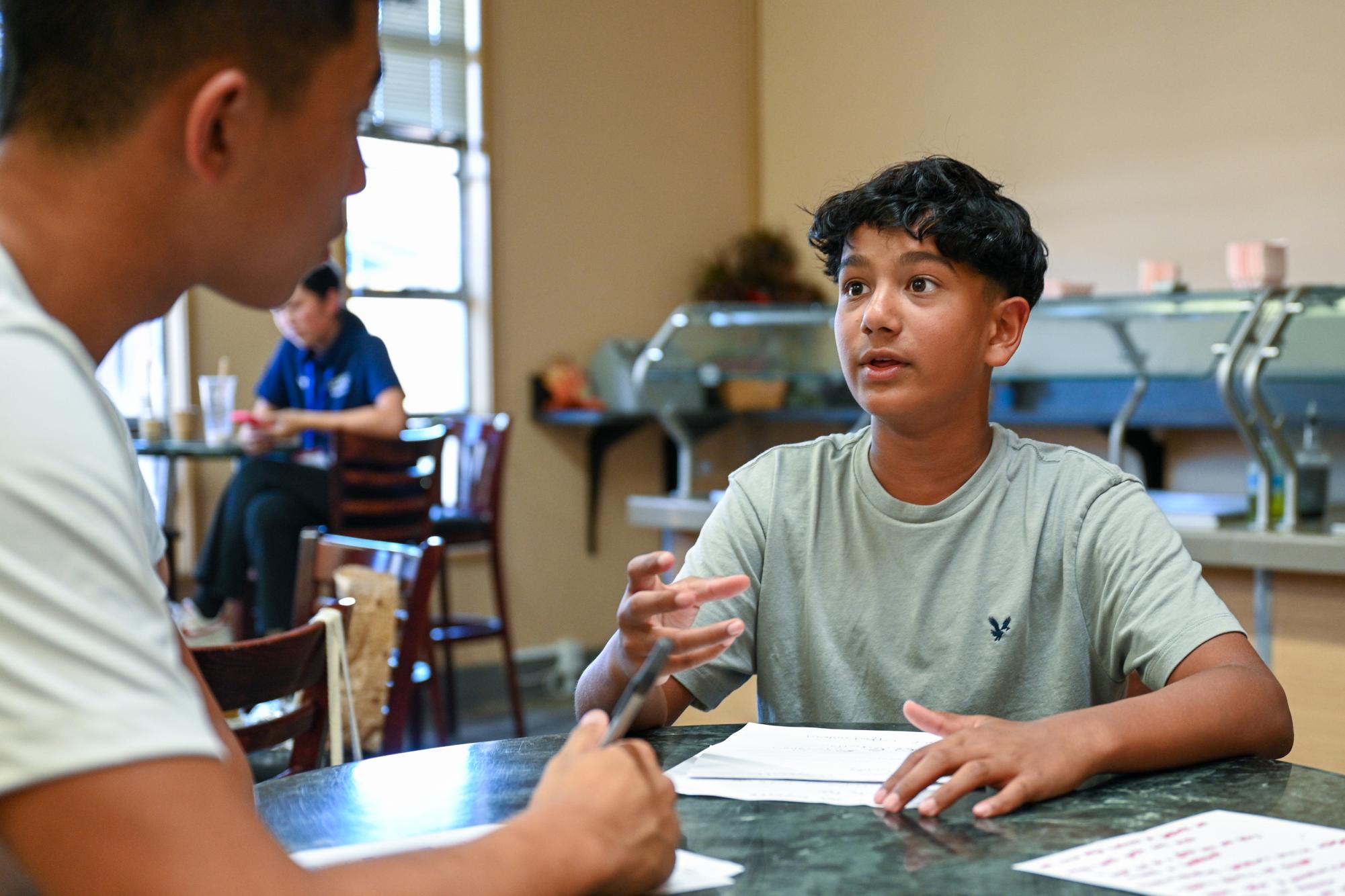 Viraaj Burli (9) pitches an idea to judge Aden Liu (10) during the roleplay competition. Competitors worked in groups of two to present a 10-minute roleplay, which simulates a fictional business scenario.