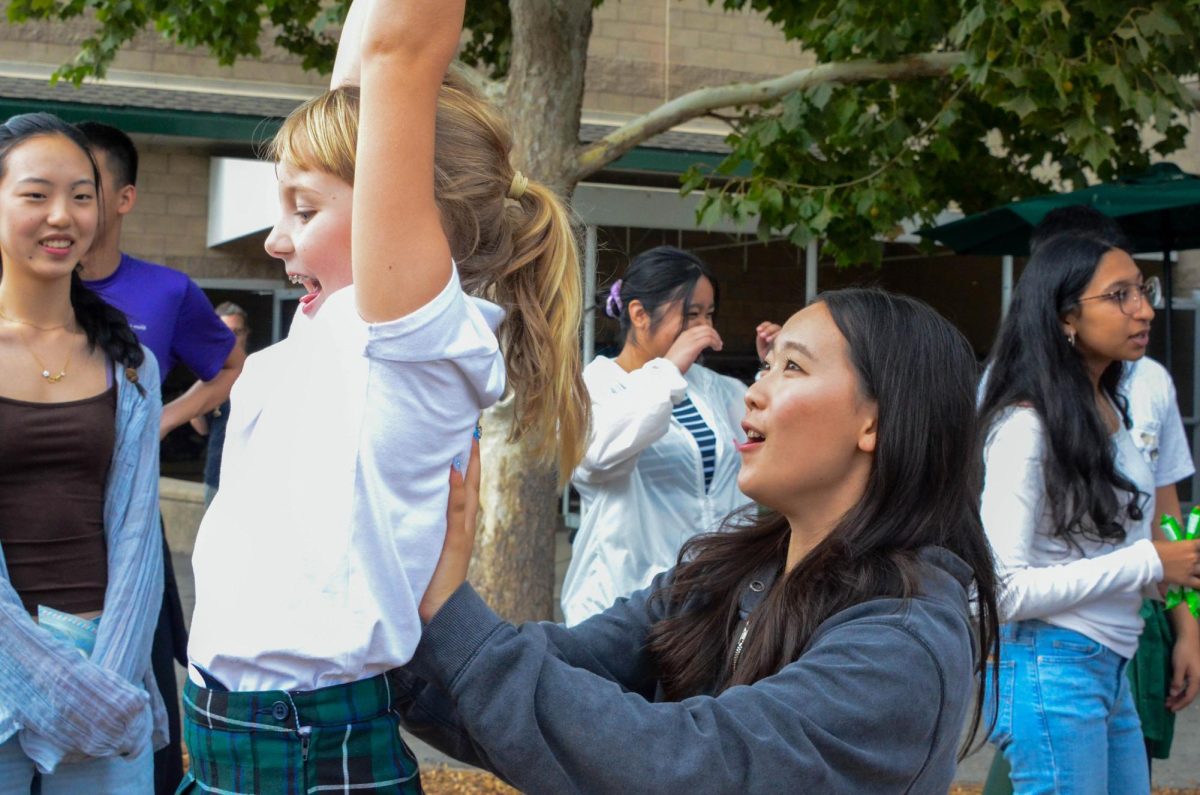 Anya Lu (10) helps push her Eagle Buddy across the zipline at the playground. Many students participated in outdoor activities after eating lunch.