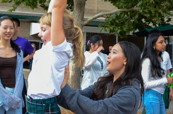 Anya Lu (10) helps push her Eagle Buddy across the zipline at the playground. Many students participated in outdoor activities after eating lunch.