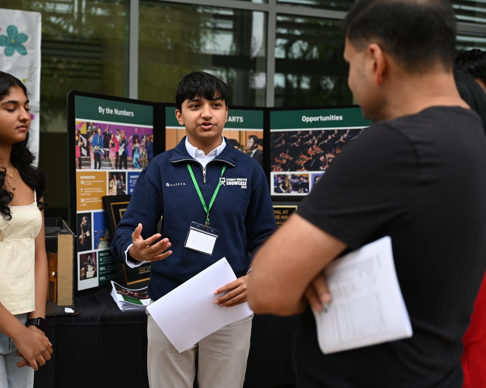 Juniors Tanisha Vaish and Ameera Ramzan promote the Conservatory to parents. Many booths for organizations such as Harker Robotics and Harker Athletics greeted the parents before they went to their first period classes.